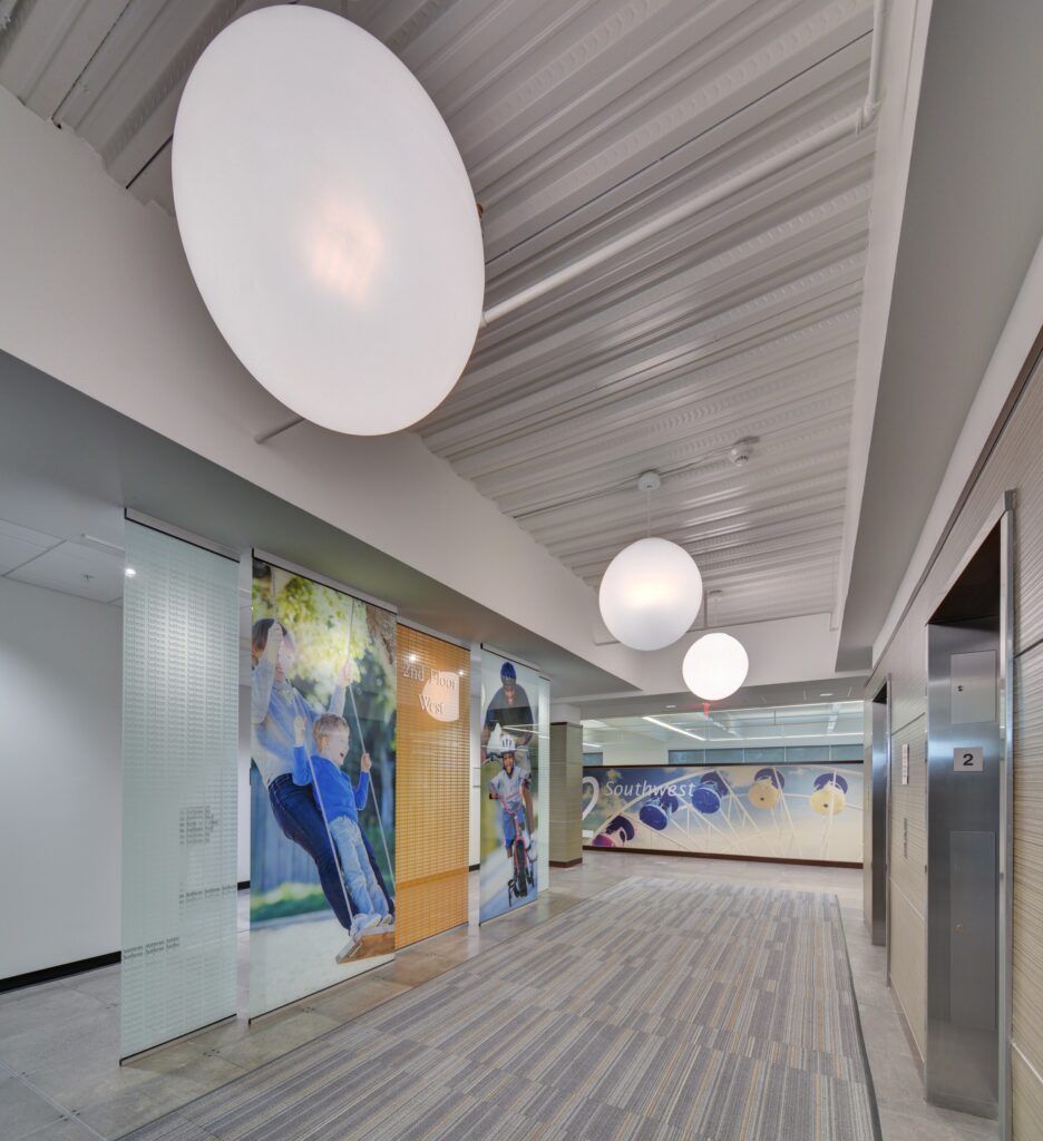 A hallway with a ceiling light hanging from it