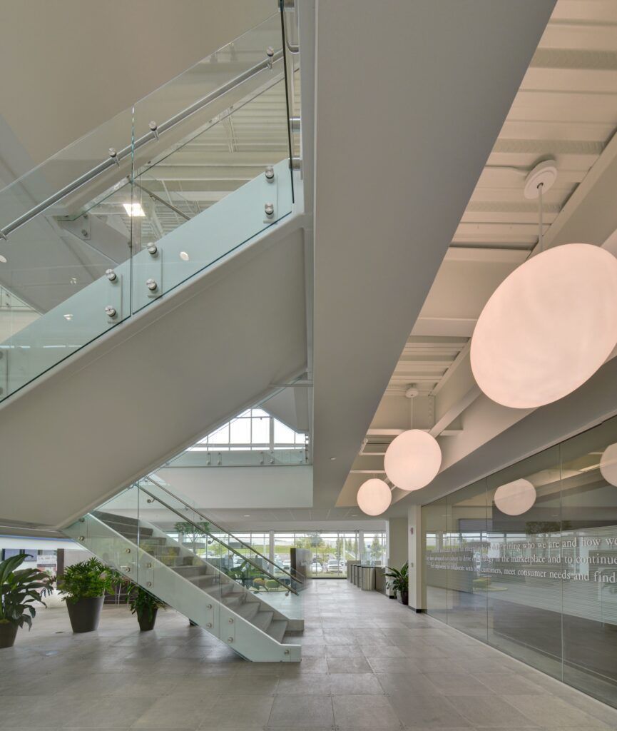 A staircase in a building with a glass railing