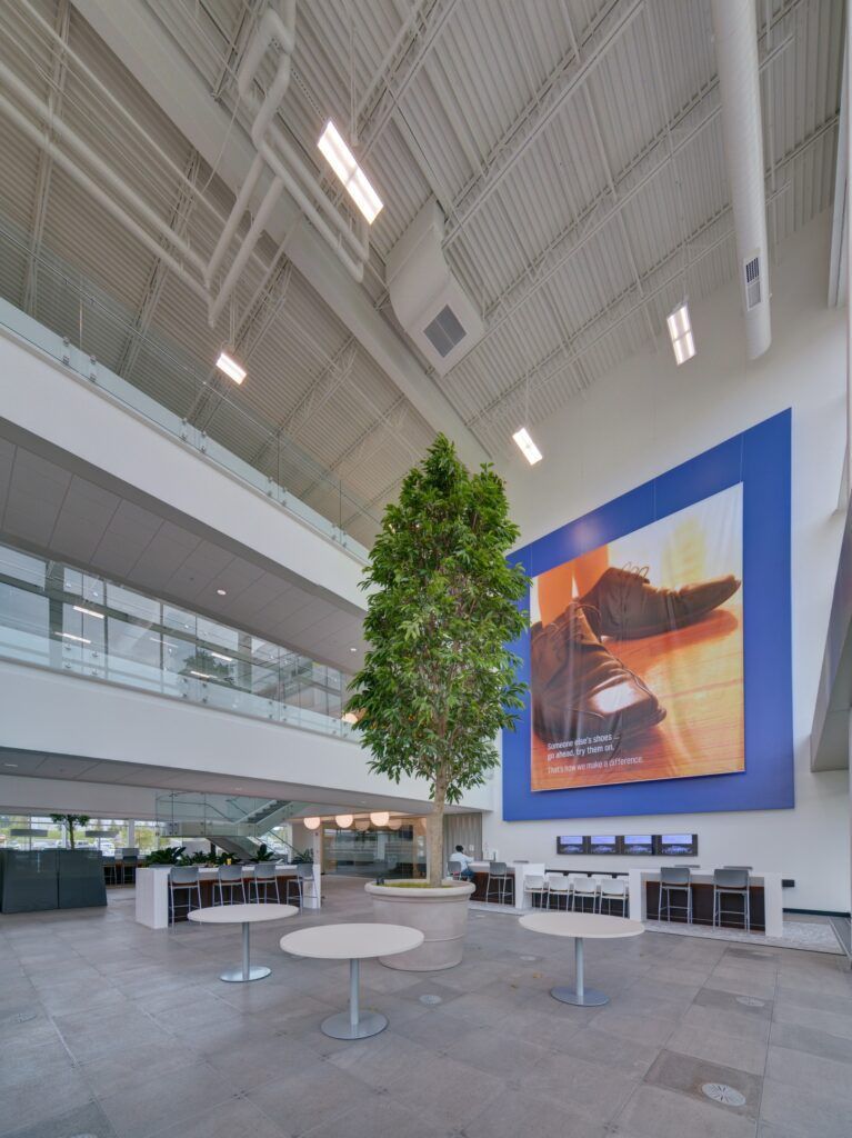 A large room with tables and a tree in the middle