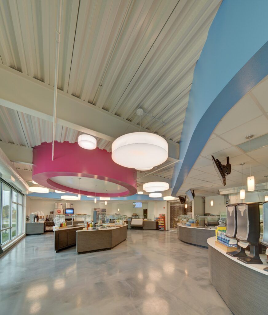 A large room with a pink circle hanging from the ceiling