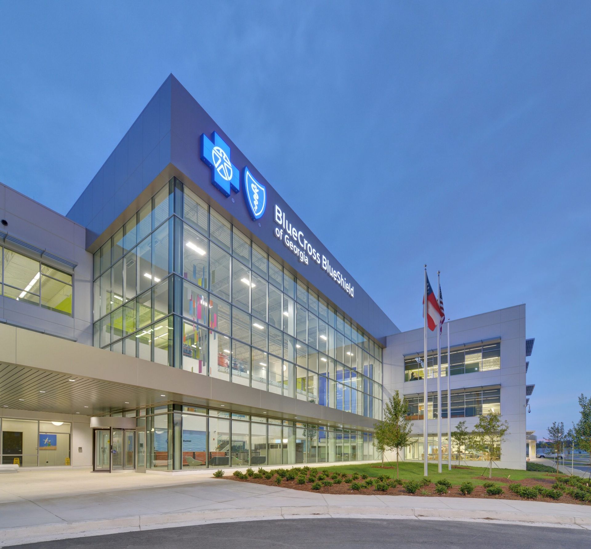 A large building with a lot of windows and a shield on it