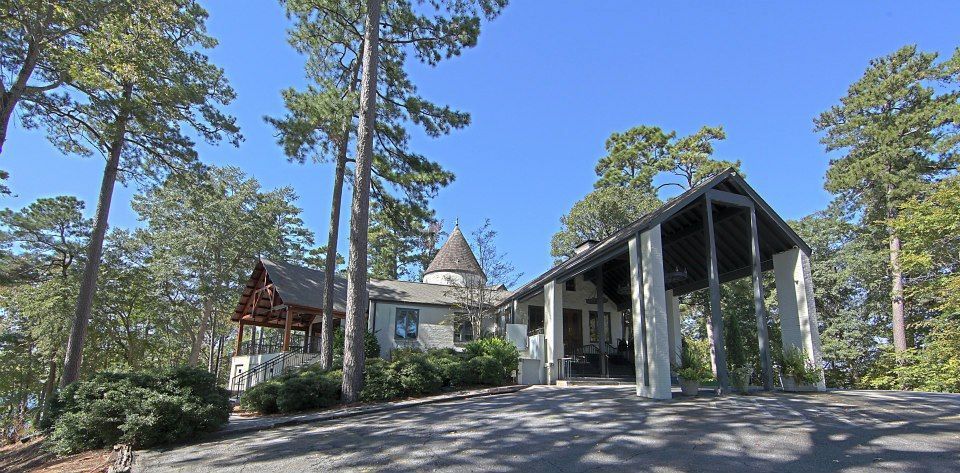 A house is surrounded by trees on a sunny day