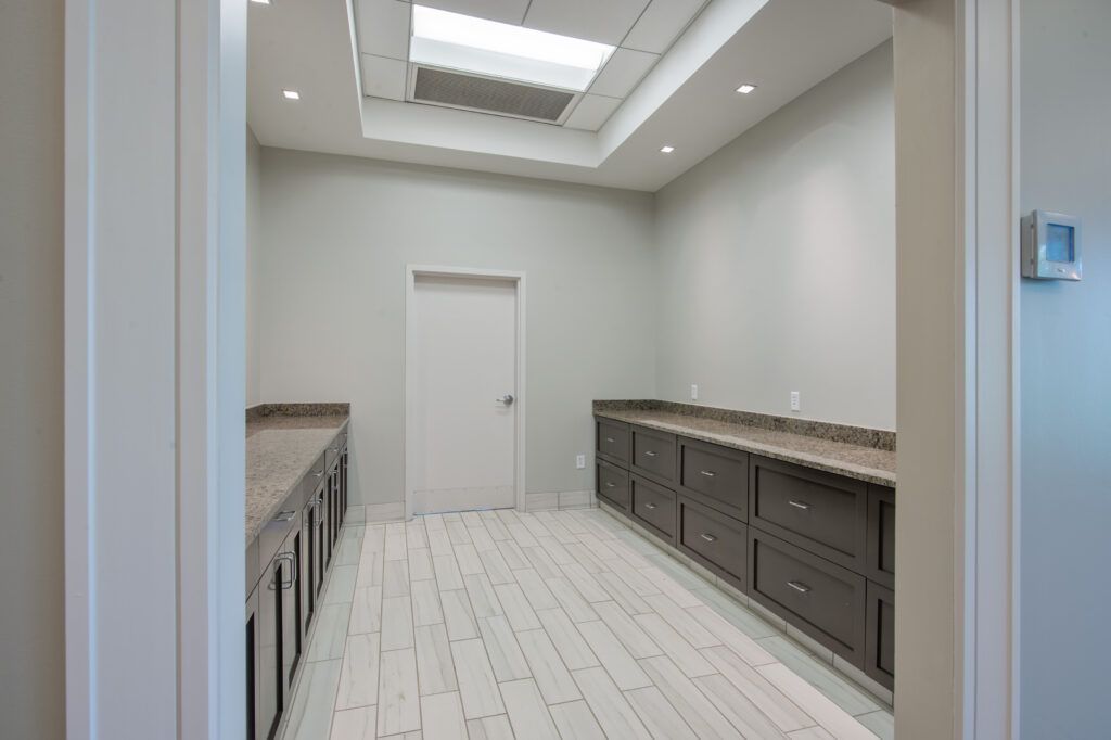 A large empty room with a lot of cabinets and drawers.