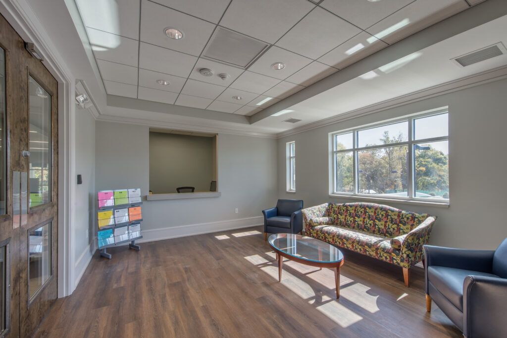 A living room with a couch , chairs , and a coffee table.