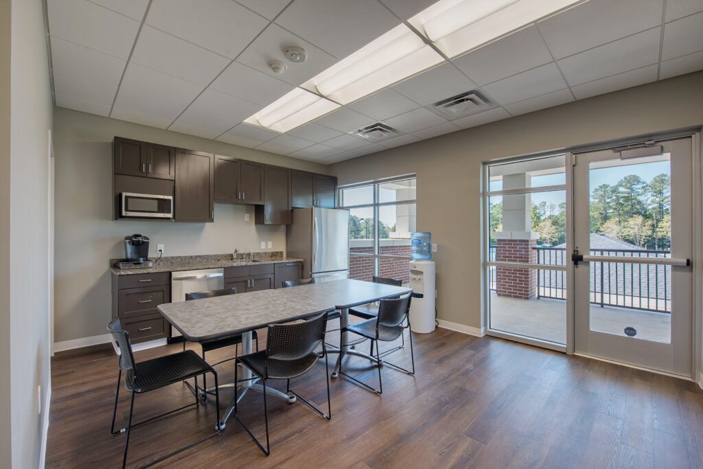 A large room with a table and chairs in it