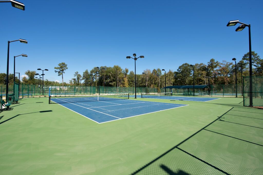 A tennis court with a lot of lights on it