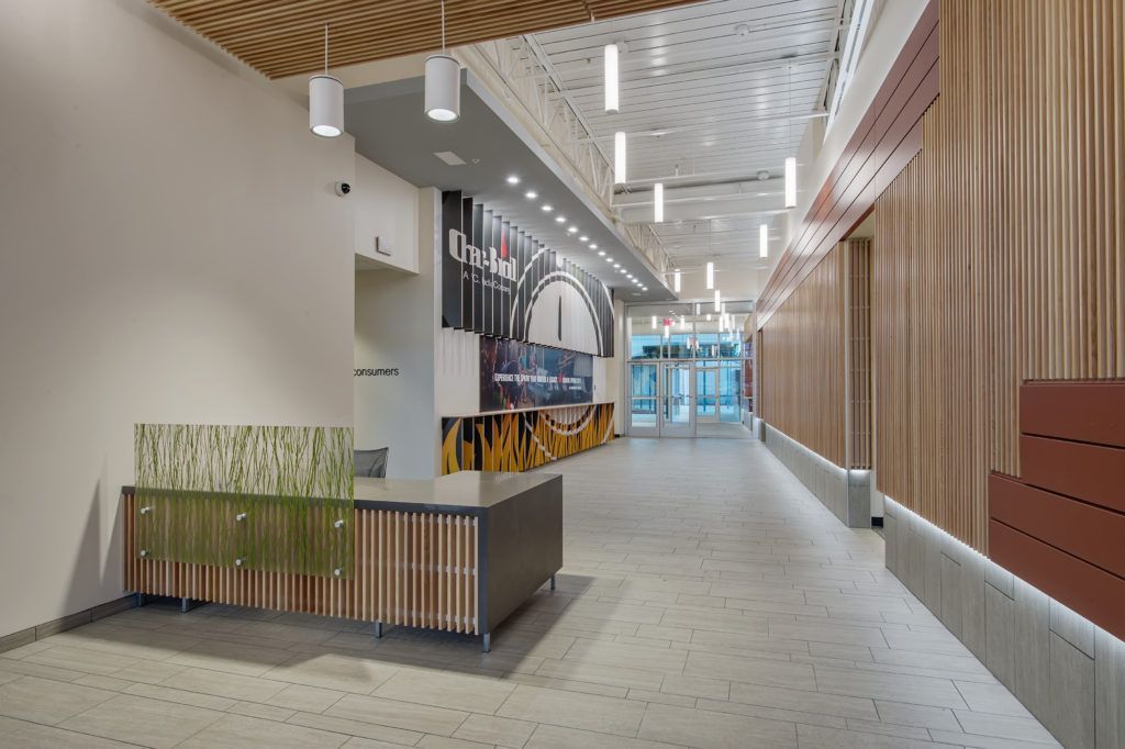 A long hallway with a desk in the middle of it