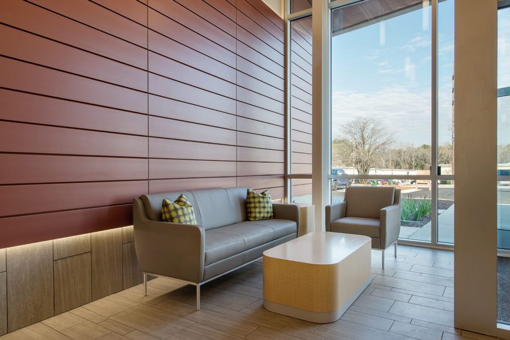 A living room with a couch and two chairs