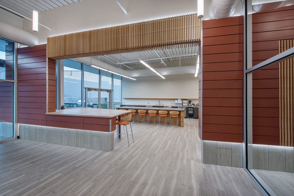 A large empty room with a table and chairs in it.