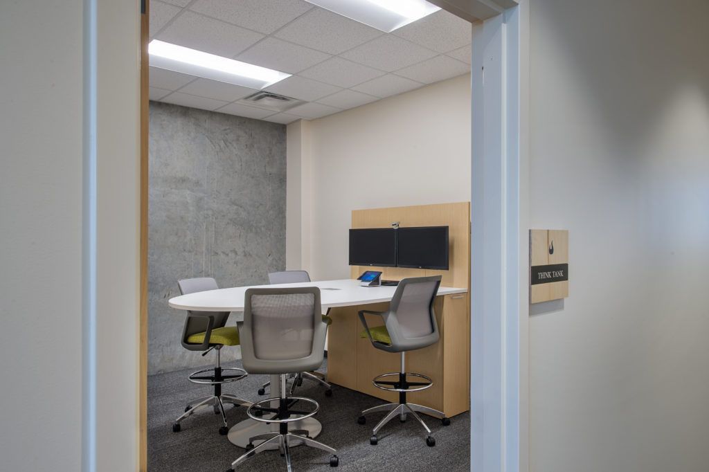 A conference room with a table and chairs in it.
