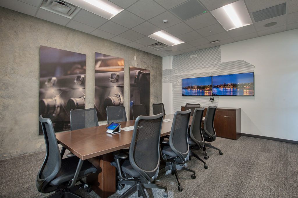 A conference room with a long table and chairs.