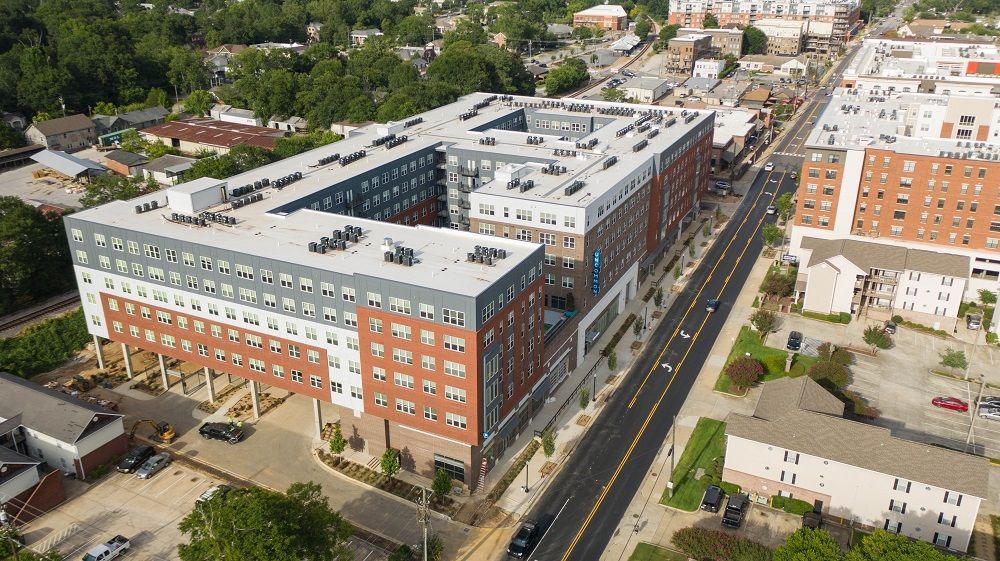 An aerial view of a large apartment building in a city.