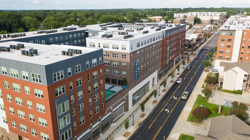 An aerial view of a city with a lot of buildings and a street.