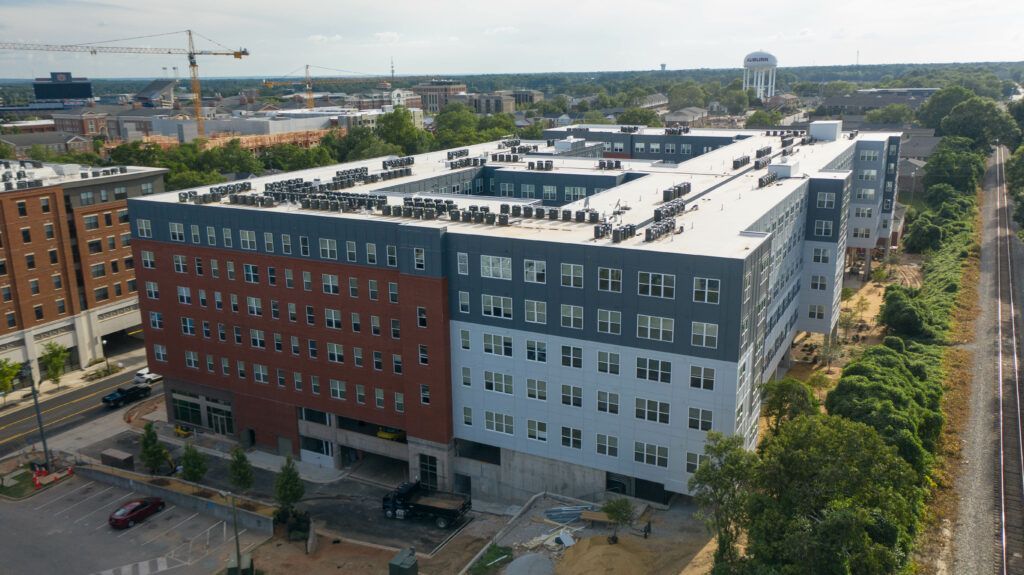 An aerial view of a large apartment building under construction in a city.