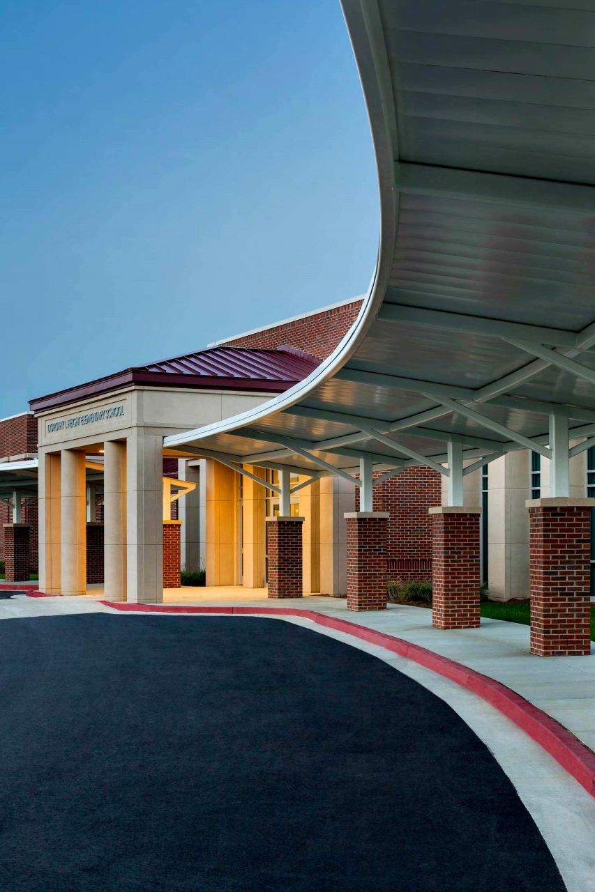 A large building with a covered walkway leading to it