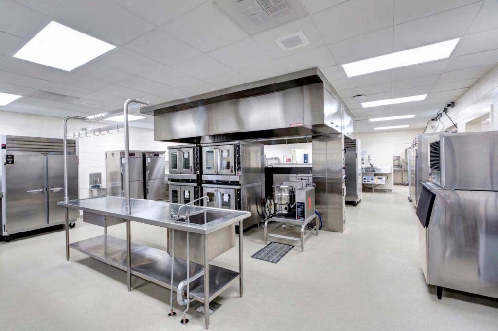 A large kitchen with a lot of stainless steel appliances.