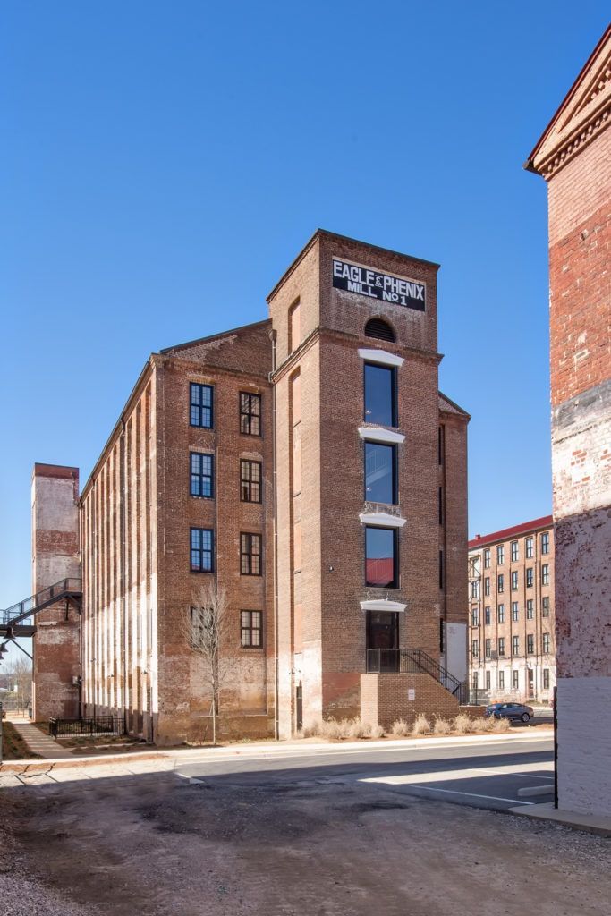 A large brick building with a clock tower on top of it.