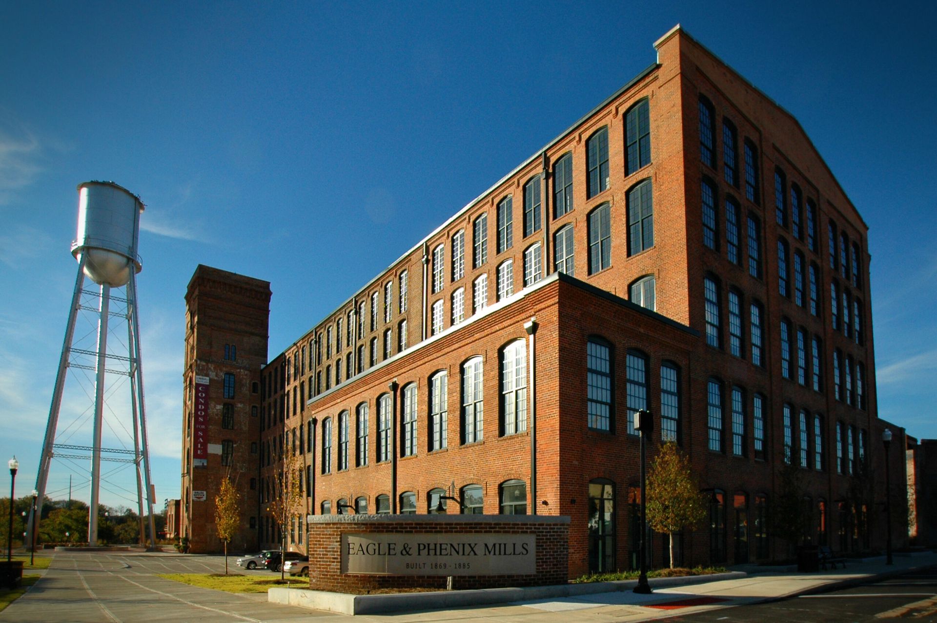 A large brick building with a water tower in the background