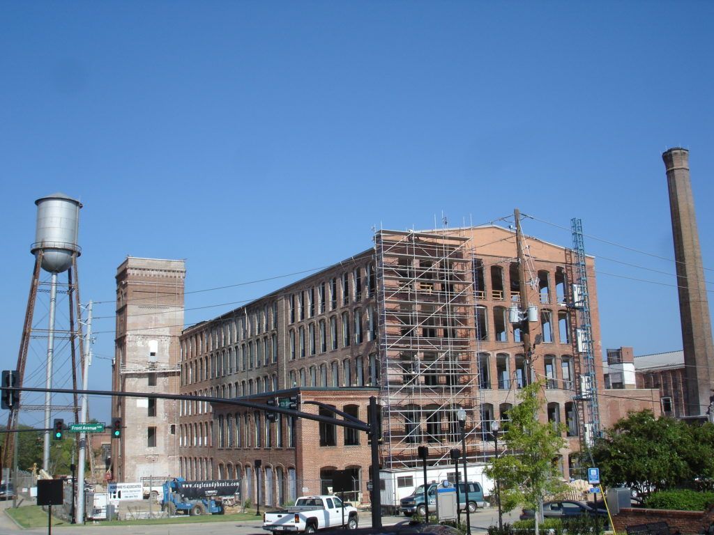 A large brick building with a water tower in front of it