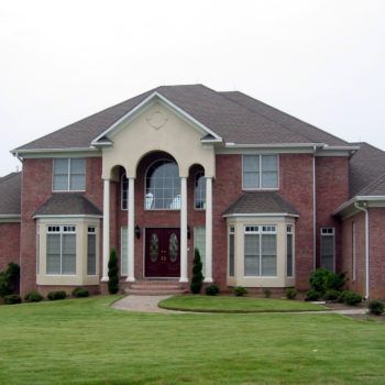 A large brick house with a gray roof