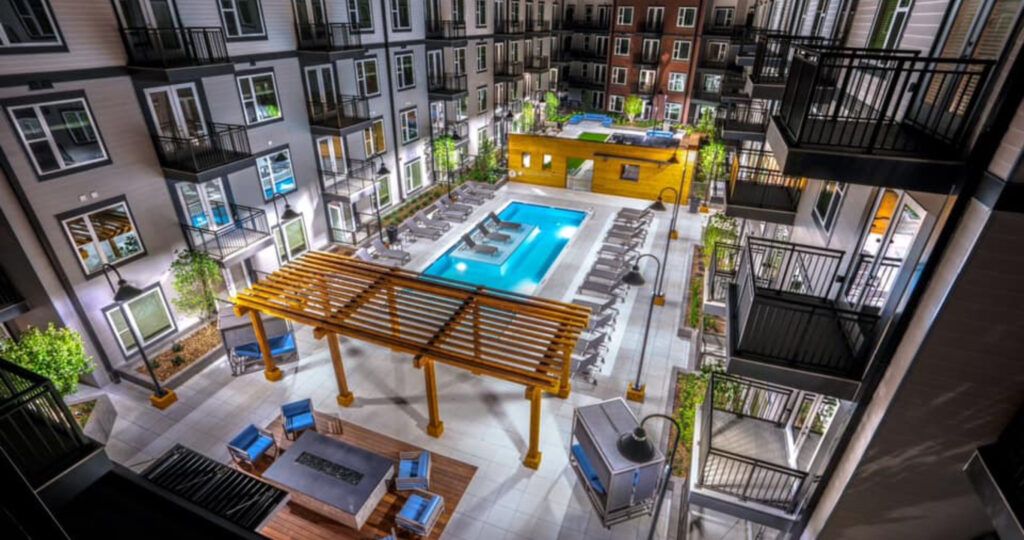 An aerial view of a large swimming pool surrounded by buildings.