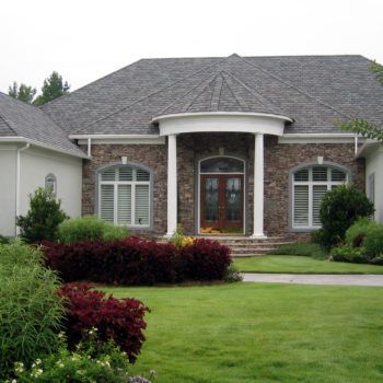 A large house with a large lawn in front of it