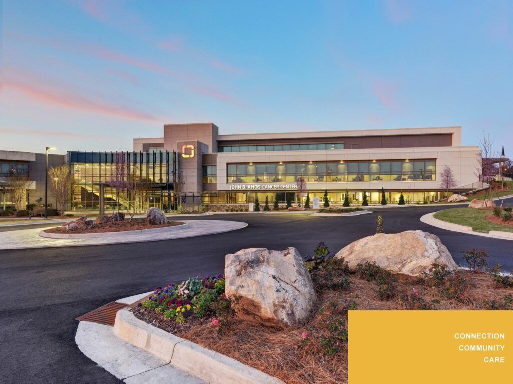 A large building with a lot of windows and a lot of rocks in front of it.