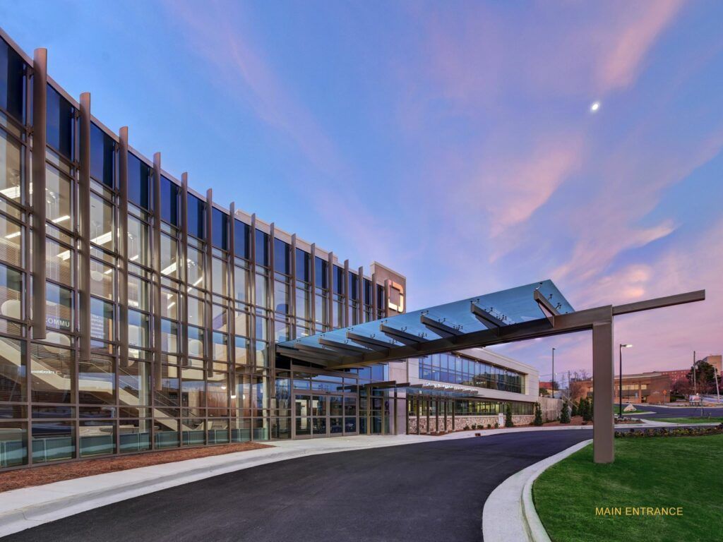A large building with a lot of windows and a canopy over the entrance.