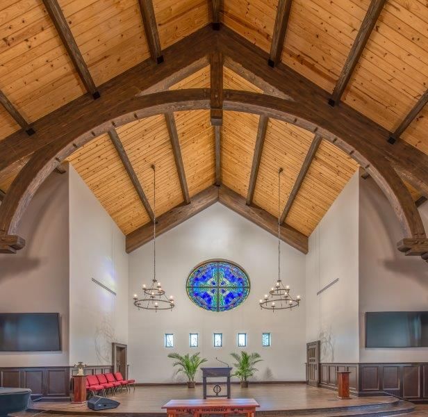 A church with wooden beams and a stained glass window