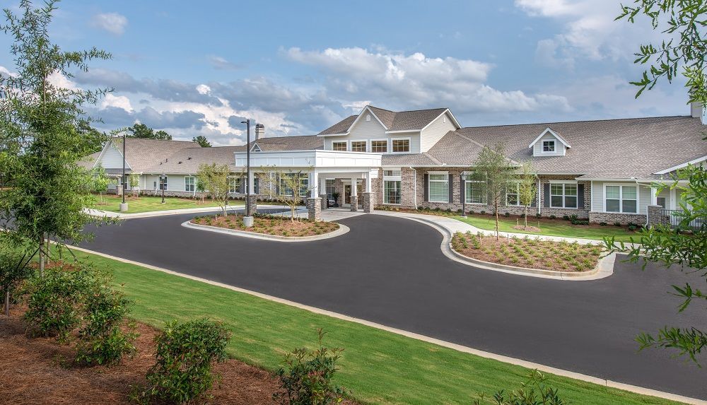 A large house with a large driveway in front of it.