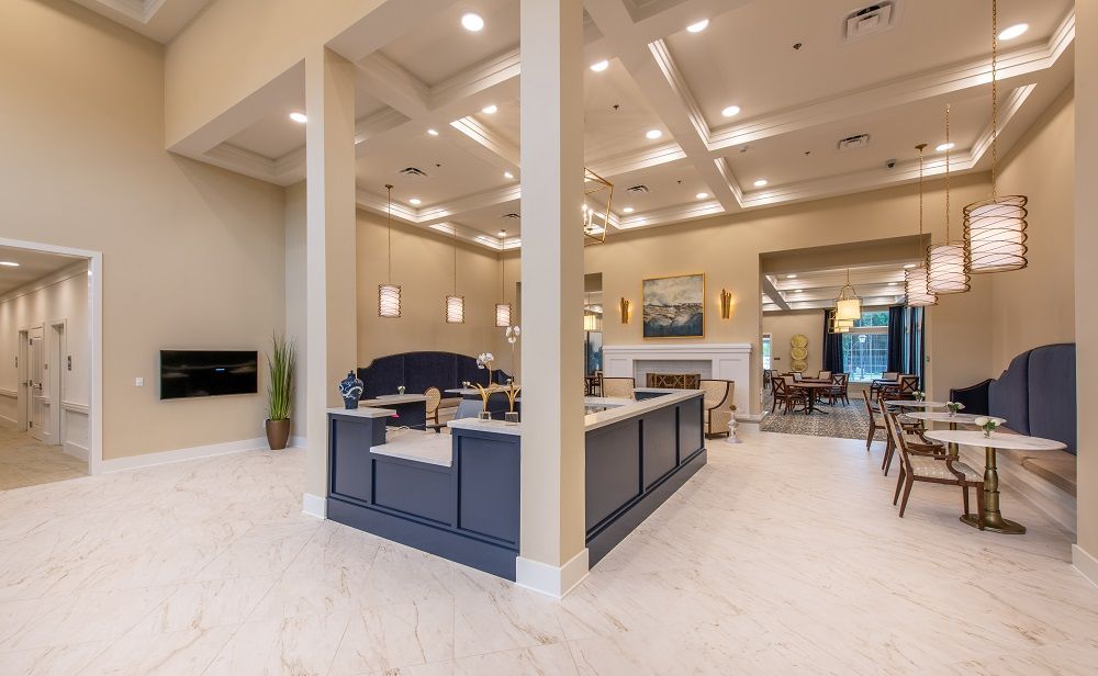 A large room with tables and chairs and a fireplace.