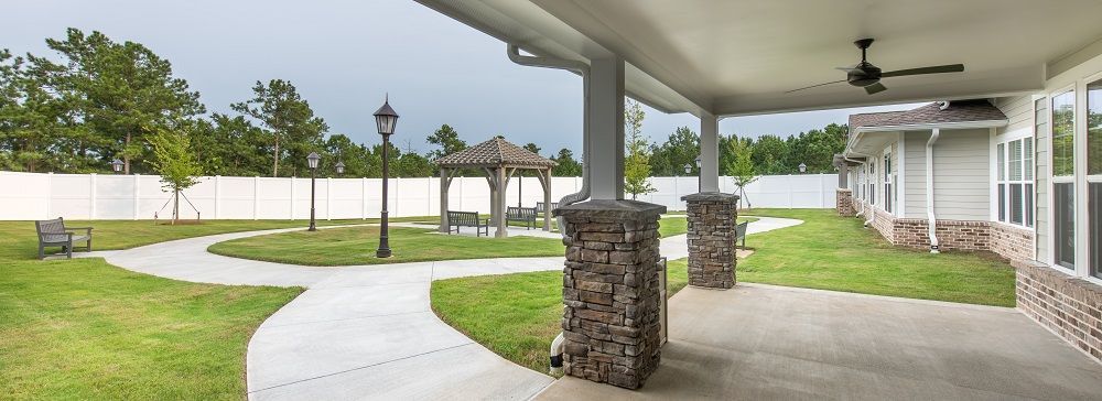 There is a gazebo in the backyard of a house.