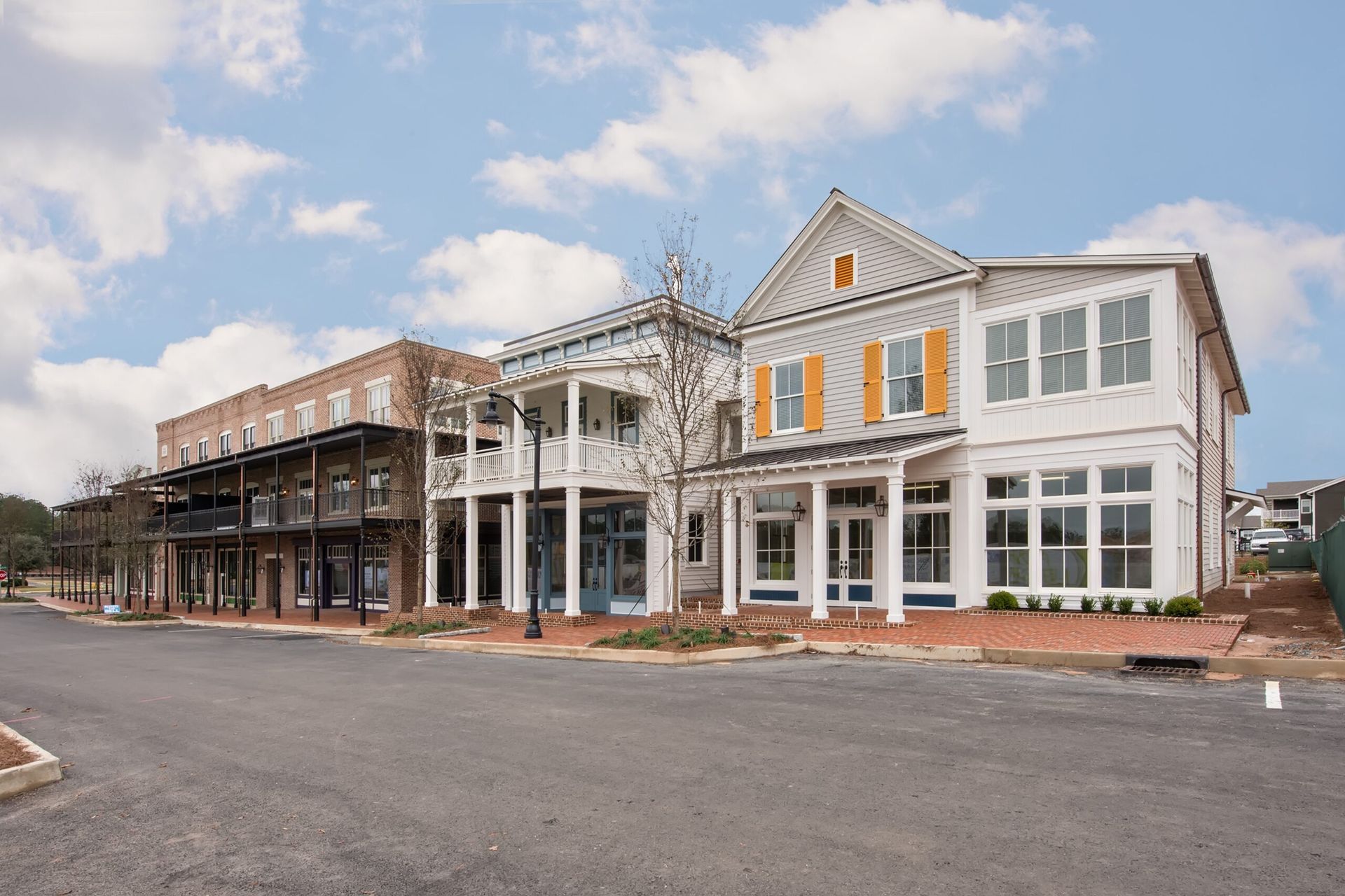 A row of buildings are lined up next to each other on a street.