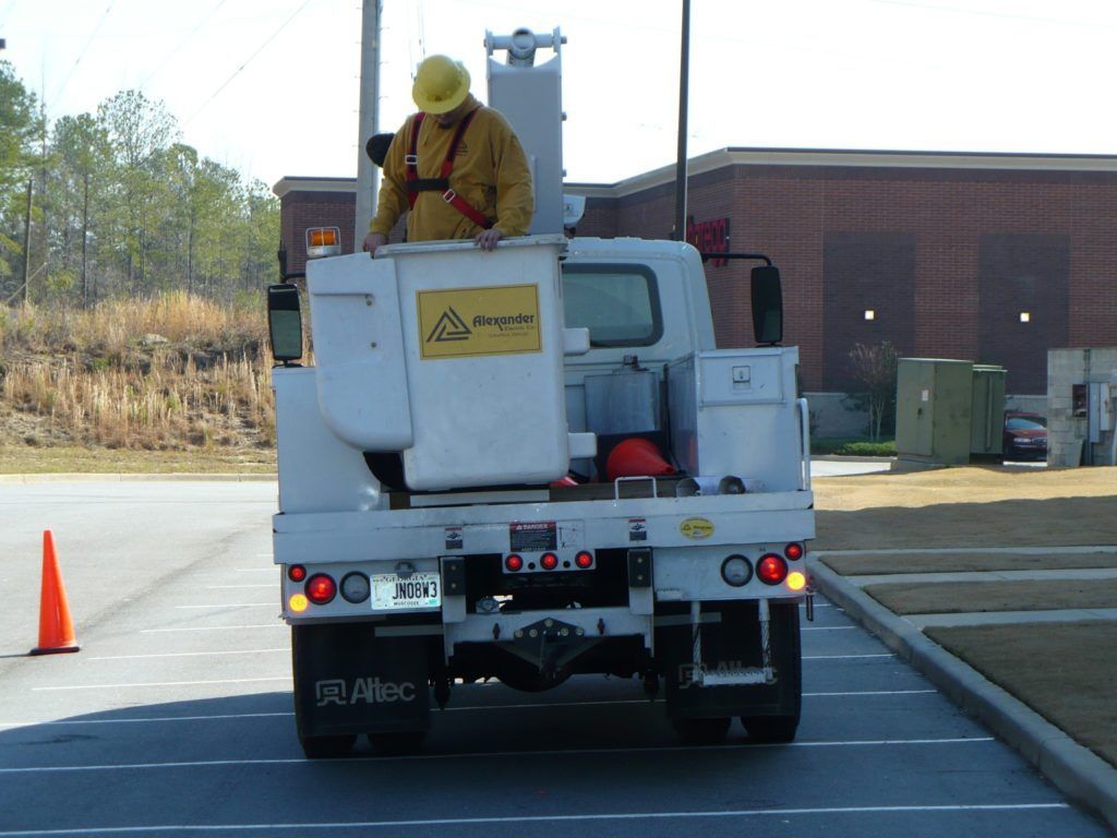 A man in a bucket on the back of a 39 allec truck