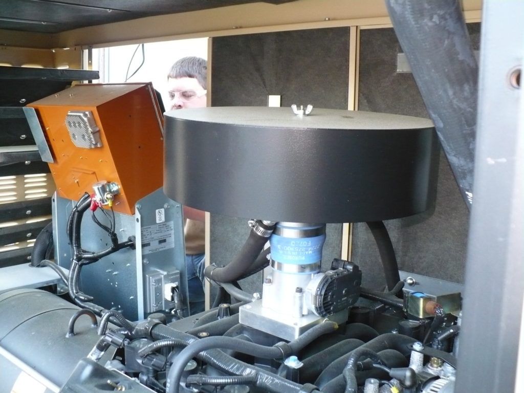 A man is working on a machine that has a filter on it