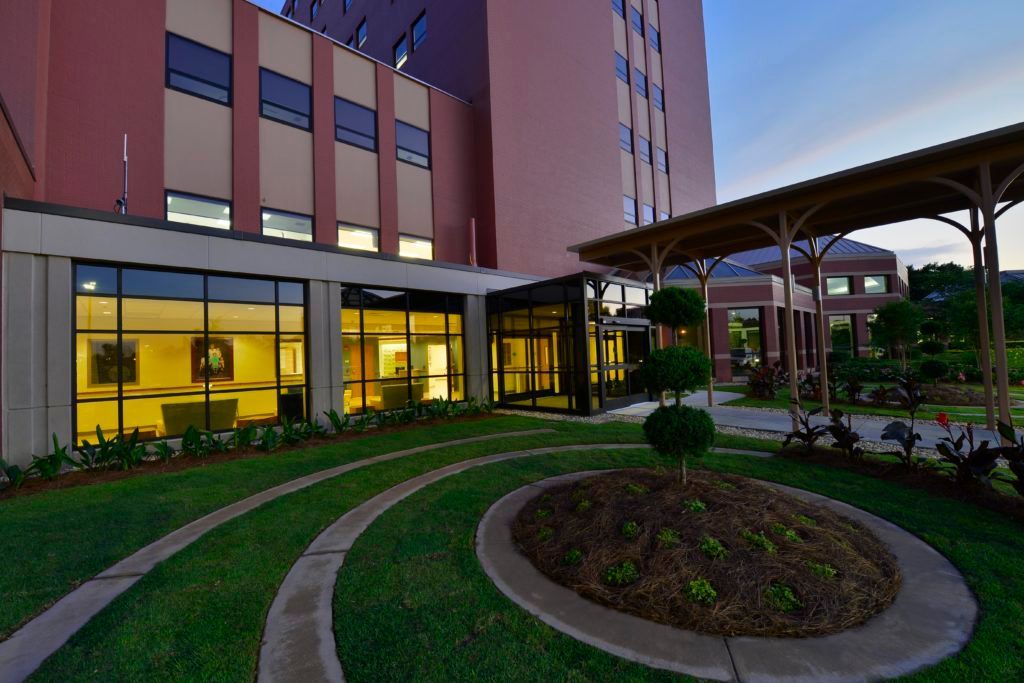 A large building with a circular garden in front of it