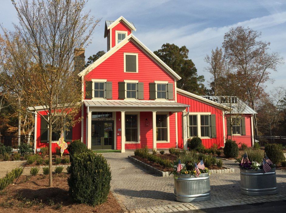 A large red house with white shutters and a porch