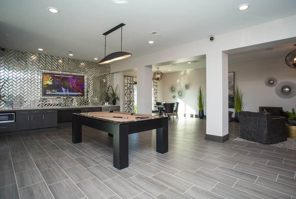 There is a pool table in the middle of the room.