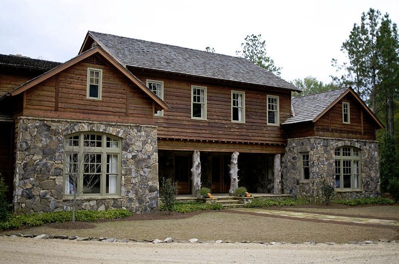 A large house with a wooden roof and stone walls