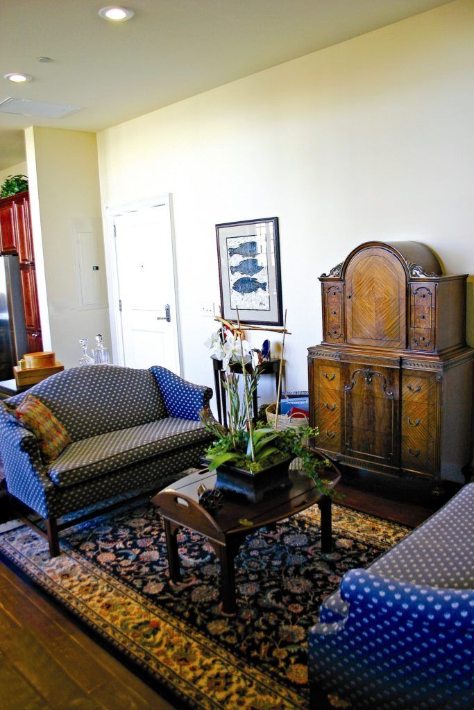 A living room with a couch a chair and a table