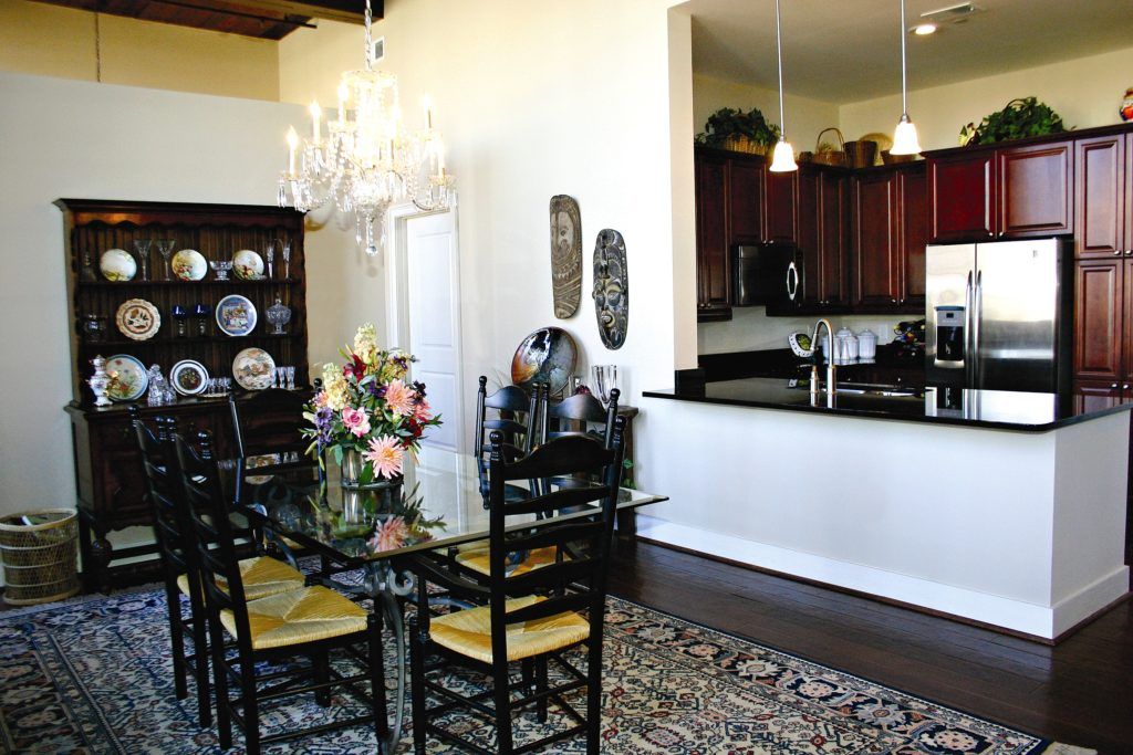 A kitchen and dining room with a glass table and chairs