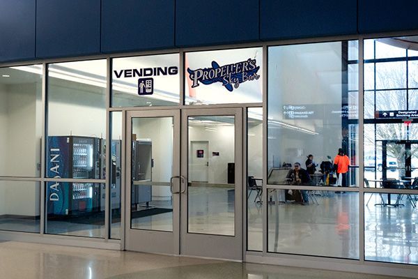 A building with a vending machine in front of it.