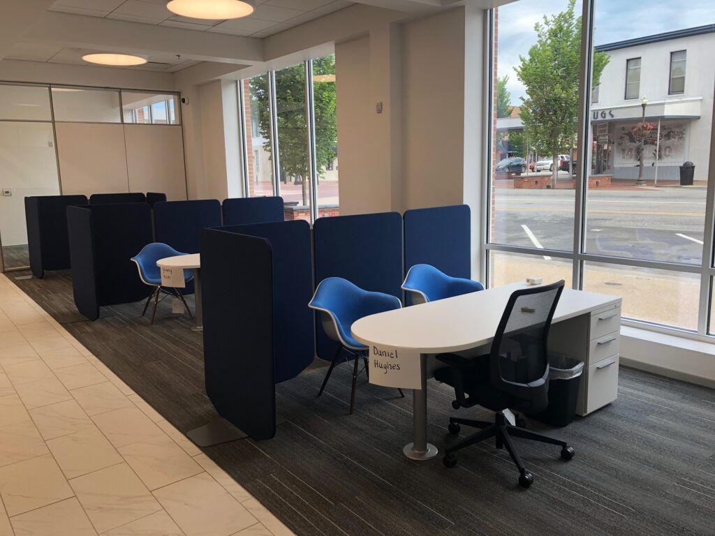 A room with a table and chairs in it and a window.
