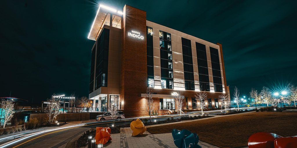 A large building with a lot of windows is lit up at night.