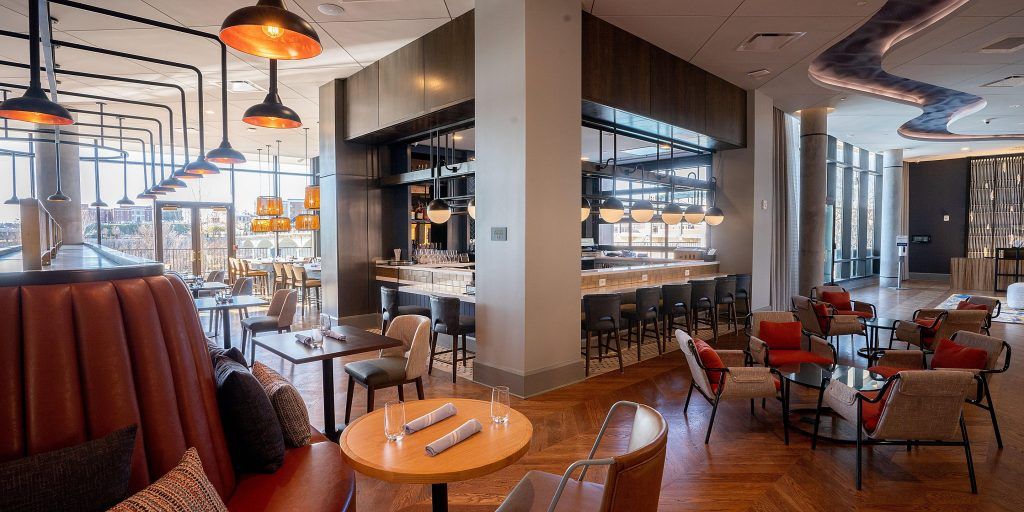 There are many tables and chairs in the restaurant.