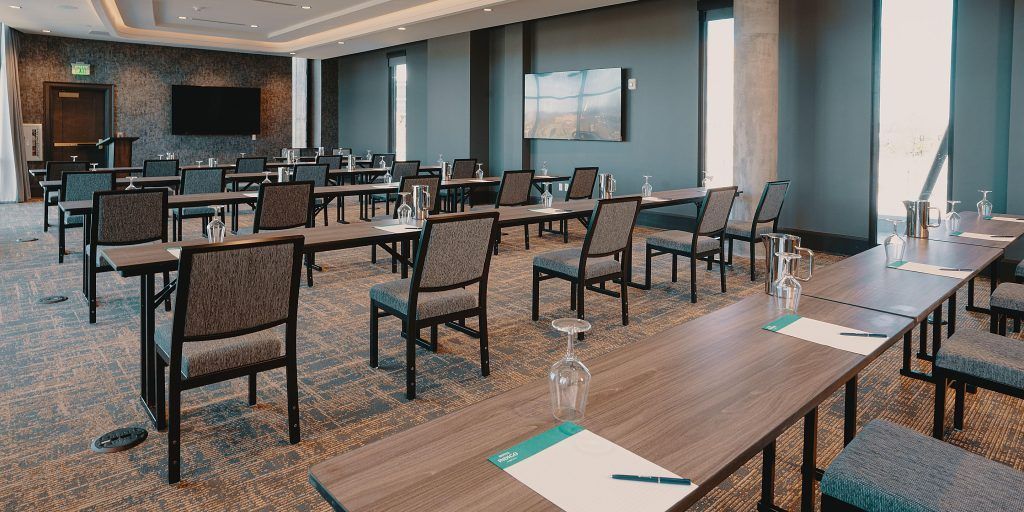 A conference room with tables and chairs set up for a meeting.