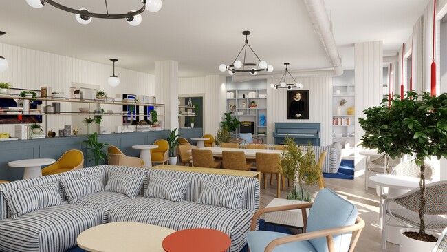 A living room with a couch , chairs , tables and a chandelier.