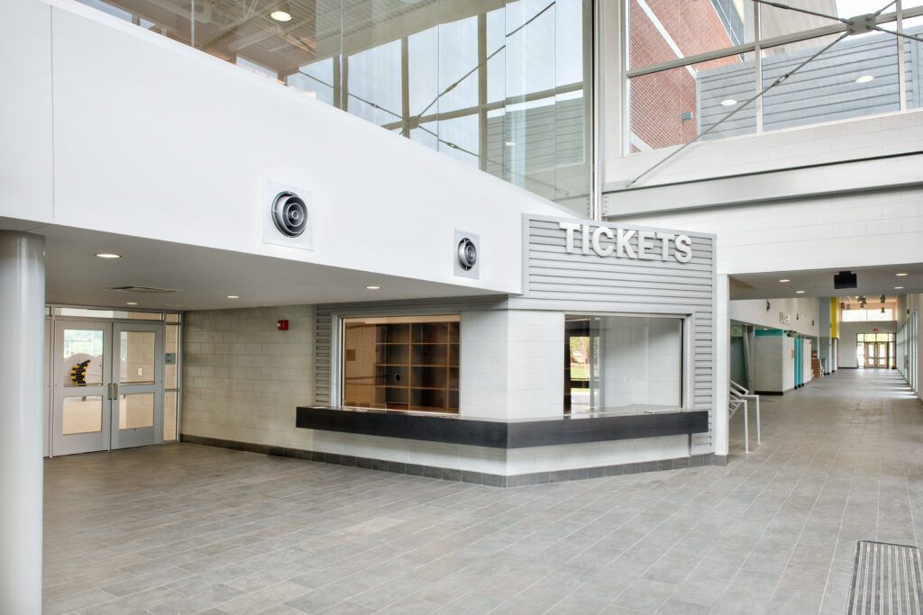 An empty lobby with a sign that says tickets