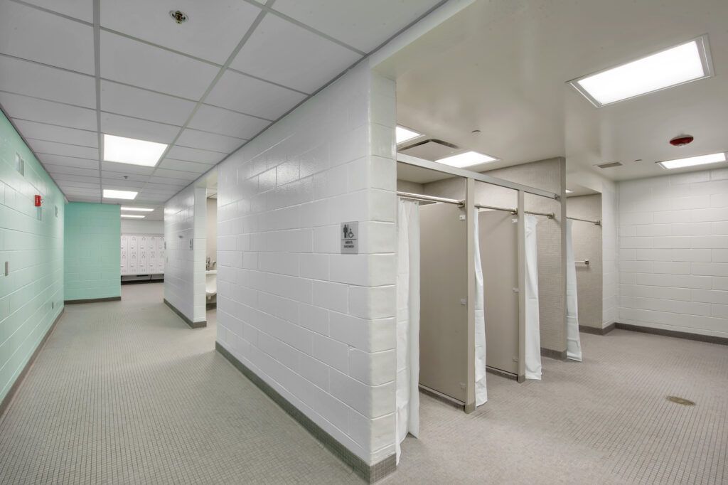A hallway with a row of cubicles in a building