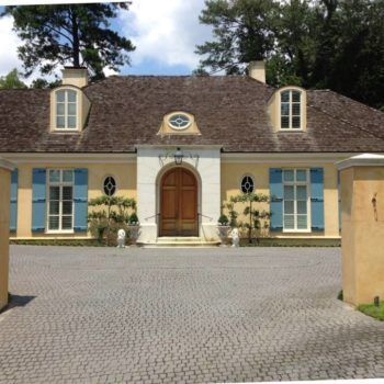 A large house with blue shutters on the windows